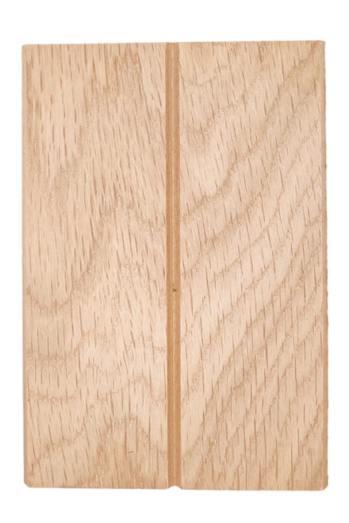 Wide plank wood panel in light finish features a central vertical groove and natural grain, ideal for modern architectural interiors. | Custom tambour and architectural wood specialists